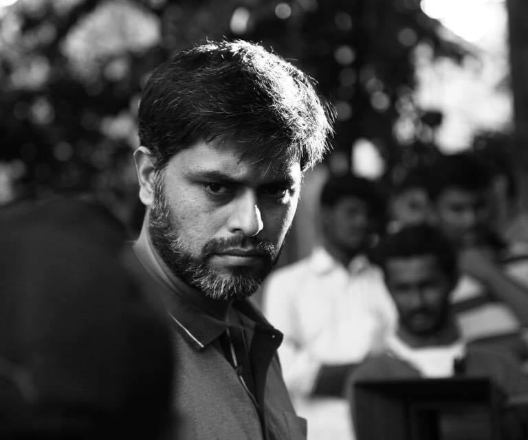 black and white photo of filmmaker himayath khan from the sets of Kannada film Just Aakasmika