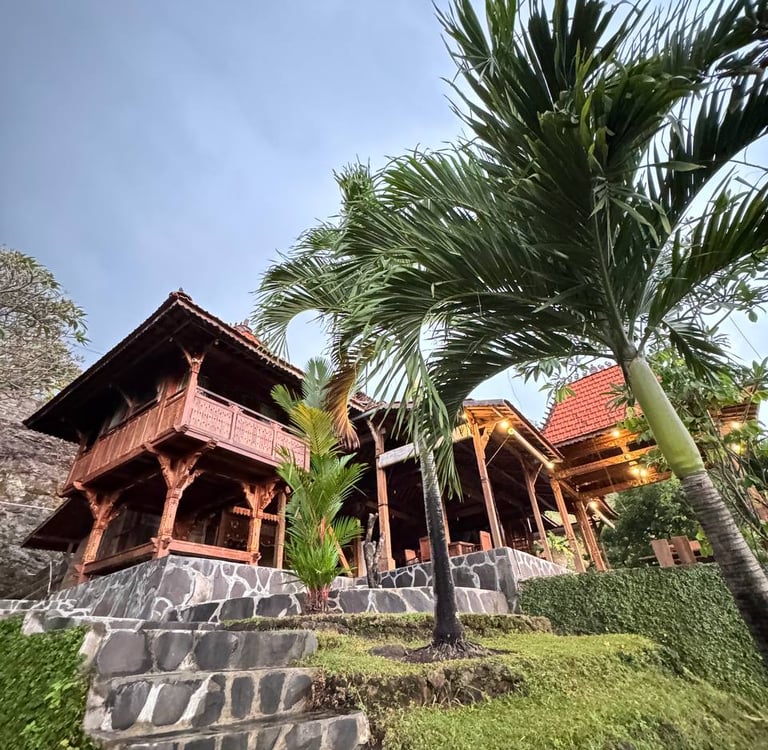 Joglo pavilion placed in tropical garden environment blending antique teak architecture with natural landscape