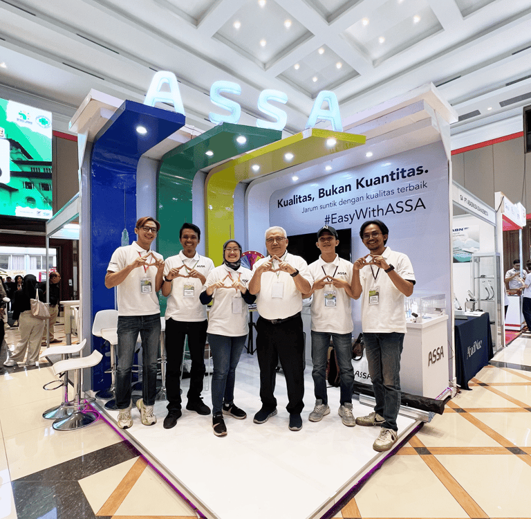 a group of people standing around a display of a group of people