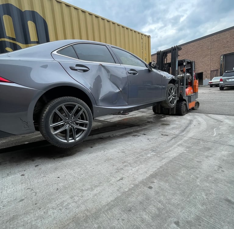 fork lift with fork extensions in use lifting a car