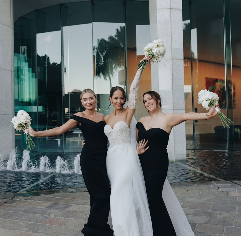 a bride and bridesmaid posing for a photo