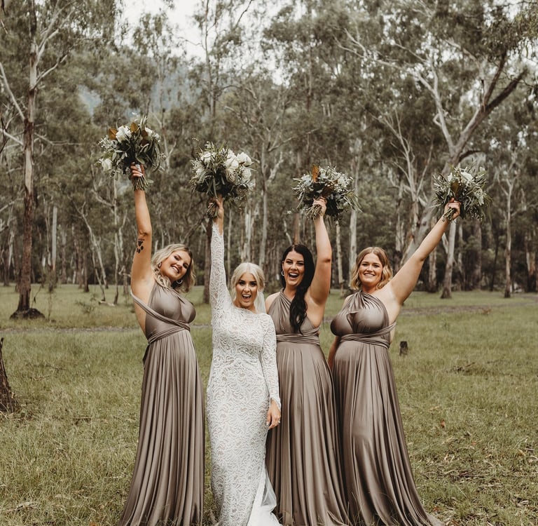 a bride and her bridesmaid posing for a photo