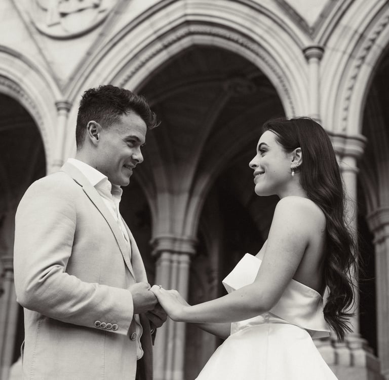 a man and woman standing in front of a building