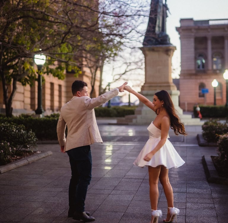 a man and woman dancing in a city