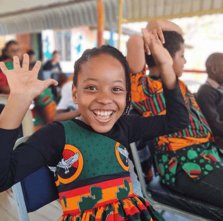 a young girl in a dress with a green dress