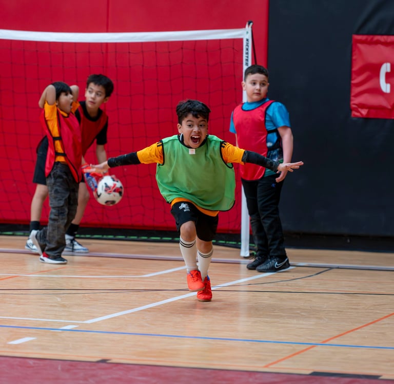 MVB FC player celebrates scoring a goal during an indoor youth soccer game indoor Mississauga