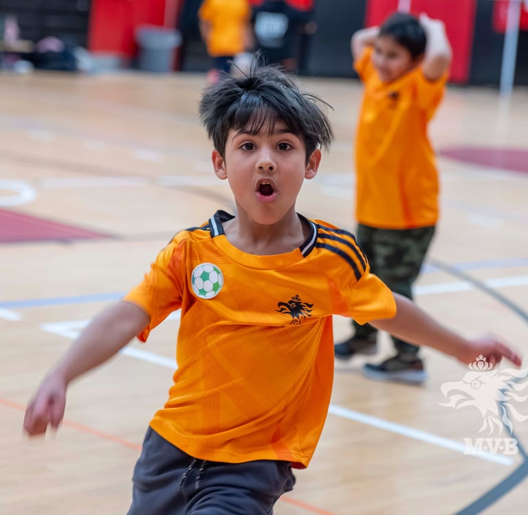 Children building confidence and coordination through beginner soccer training for kids