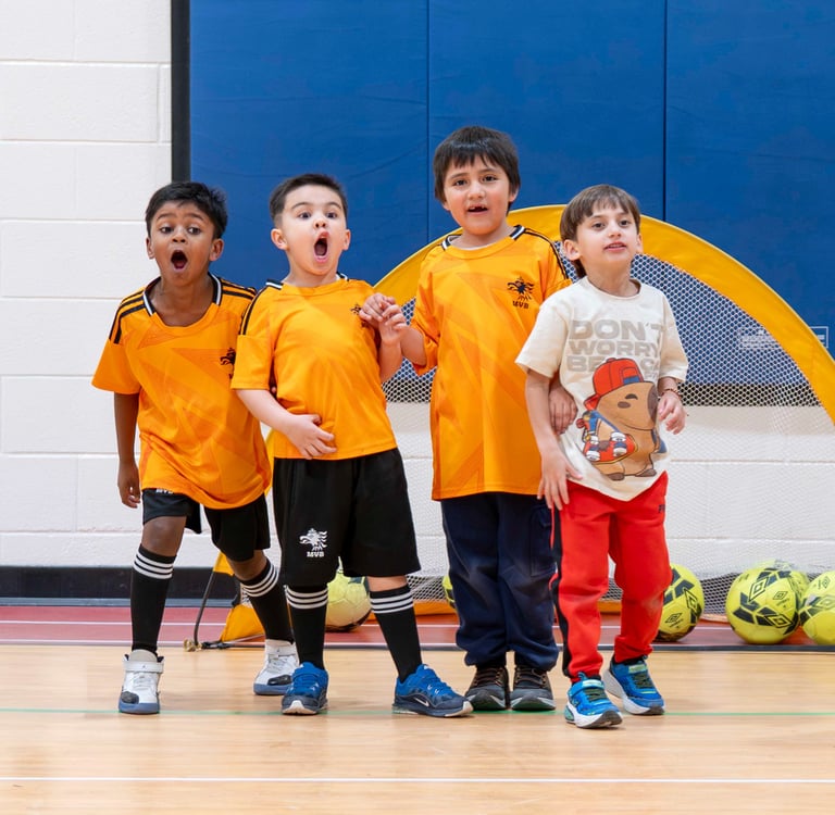 Children building confidence and coordination through beginner soccer training for kids