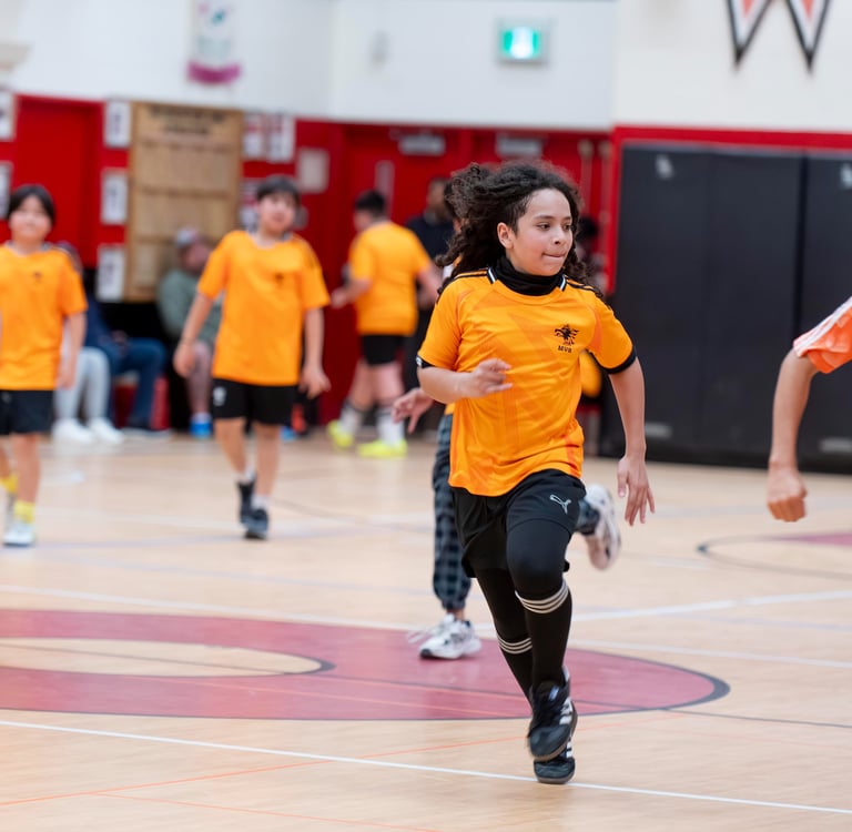 Young soccer players in a competitive indoor soccer game MVB FC Soccer School in Mississauga