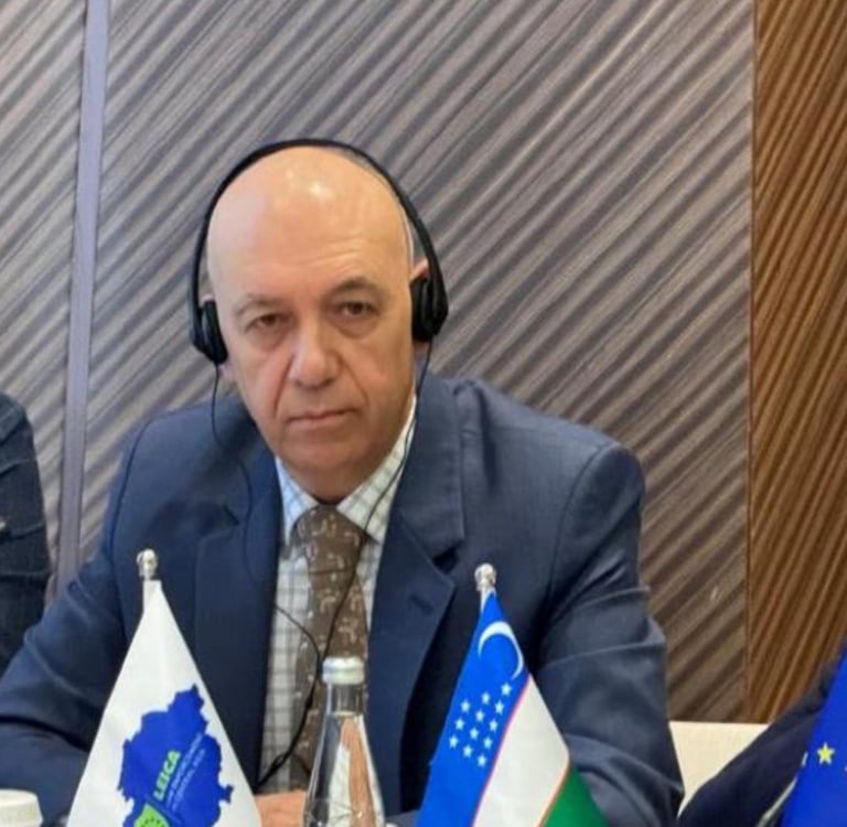 a man in a suit and headphones sitting at a table
