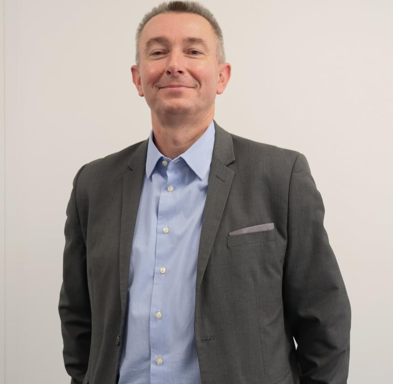 a man in a suit and tie smiling