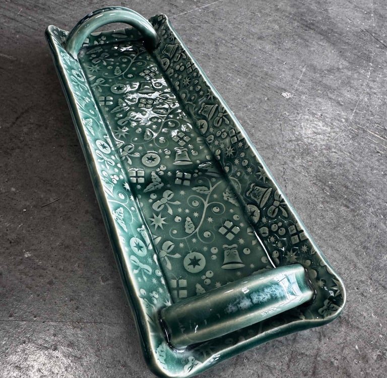 A handmade textured cracker tray with handles. 