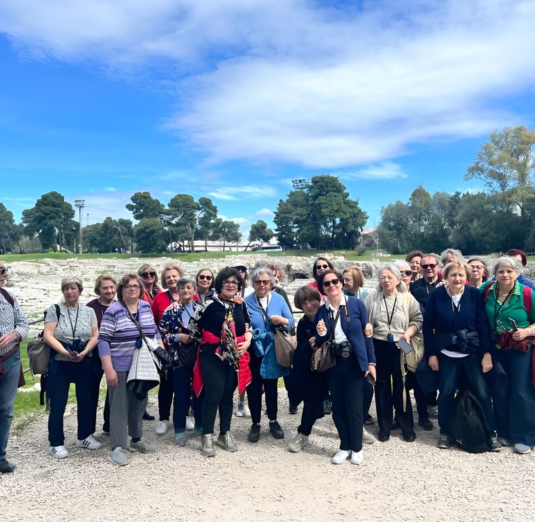a group of people standing in front of a fence