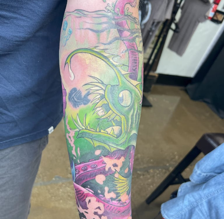 a man with a tattoo on his arm of a fish color tattoo