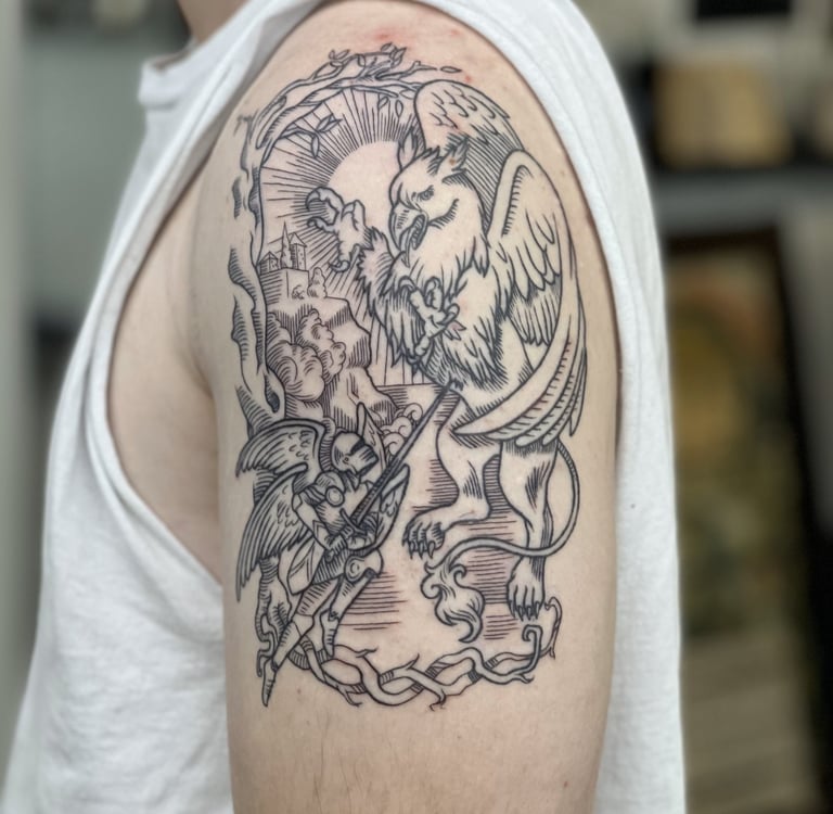 a man with a tattoo on his arm. Line art tattoo of mythology griffin fight