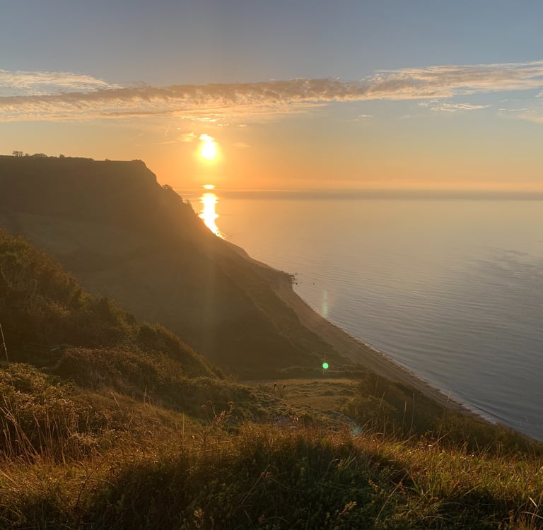 A view of the sunset overlooking the ocean and coast