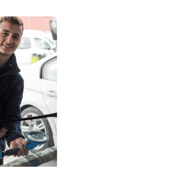 a man is holding a car with a car washer