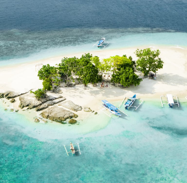 a small island with boats and trees in the water, Snorkeling & Keliling Pulau Gili Barat Daya