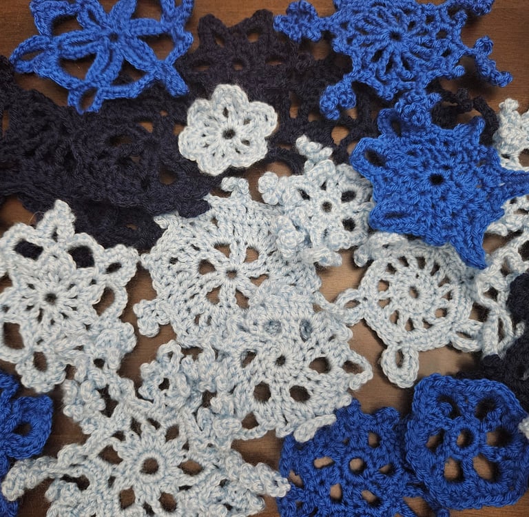 crochet snowflakes on a wooden table
