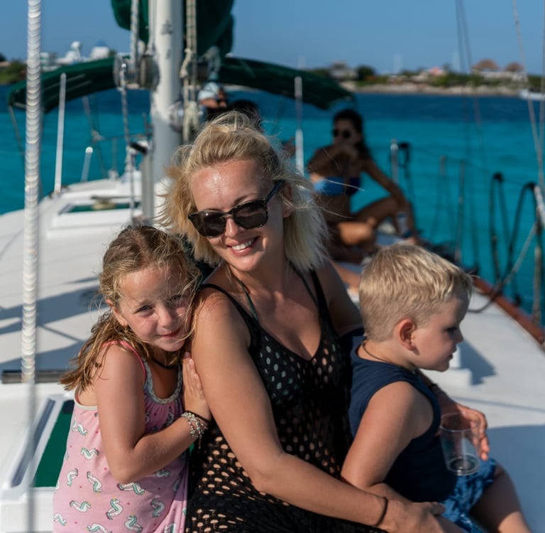 a woman and two children on a boat in cancun 