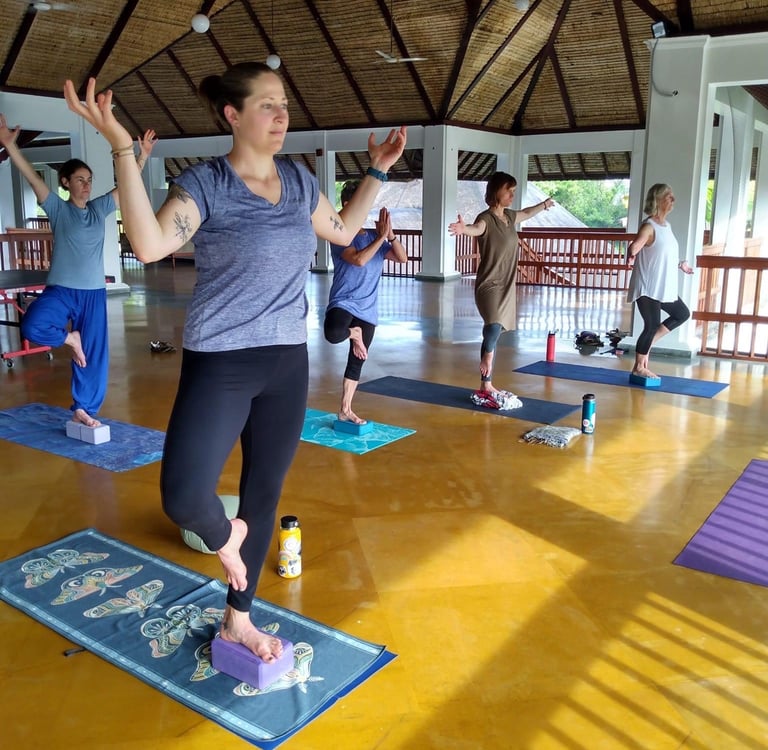 a woman in a yoga pose with a yoga mat