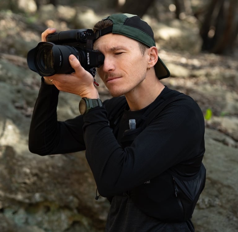a man taking a picture of himself in the woods