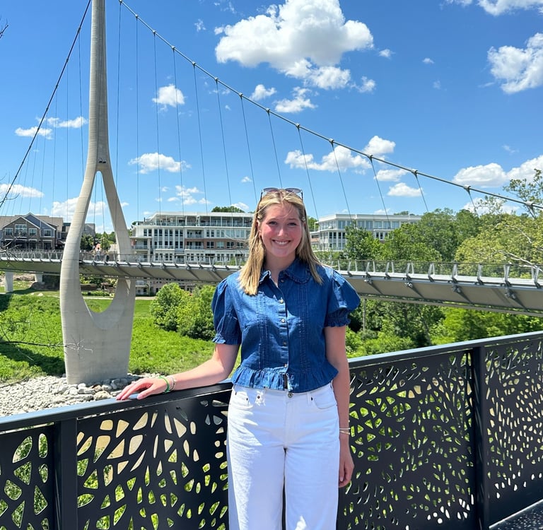 Young woman standing in front of The Link bridge