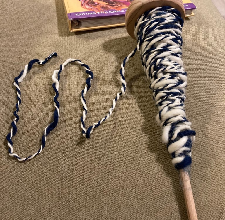 A beginner attempt at plying wool on an Ashford student spindle