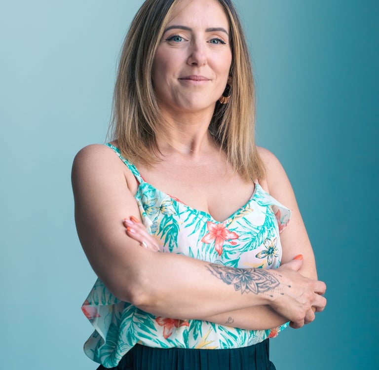 a woman with tattoos on her arms and arms crossed