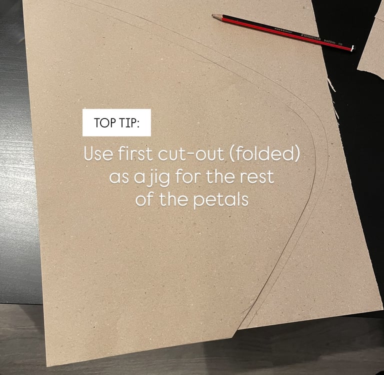 brown paper petal folded in half to use as a jig or mould