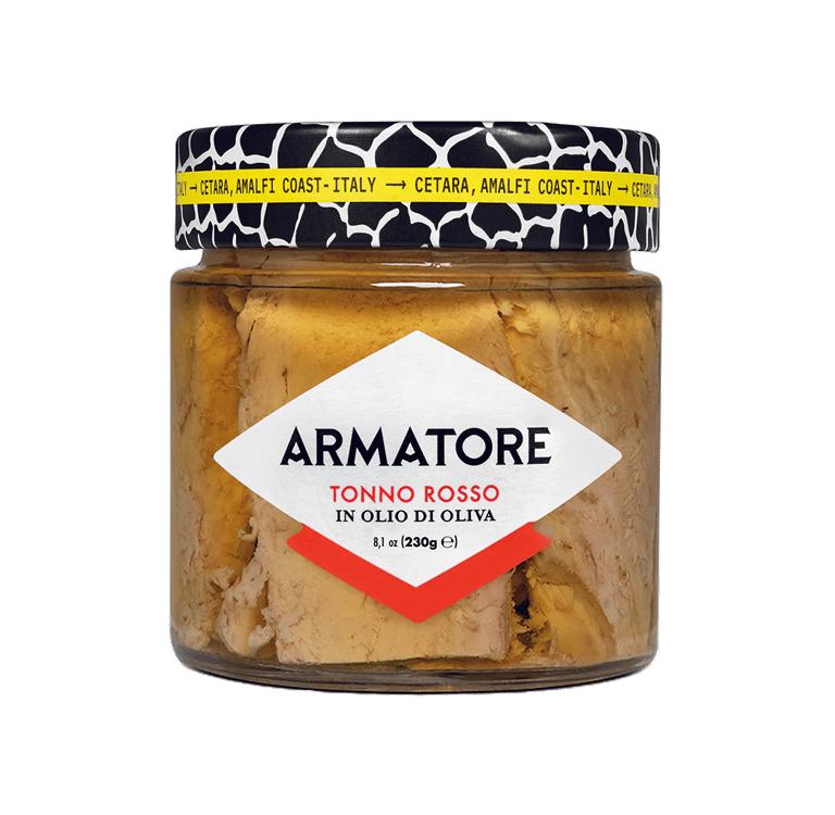 a jar of food with a cat sitting on a table