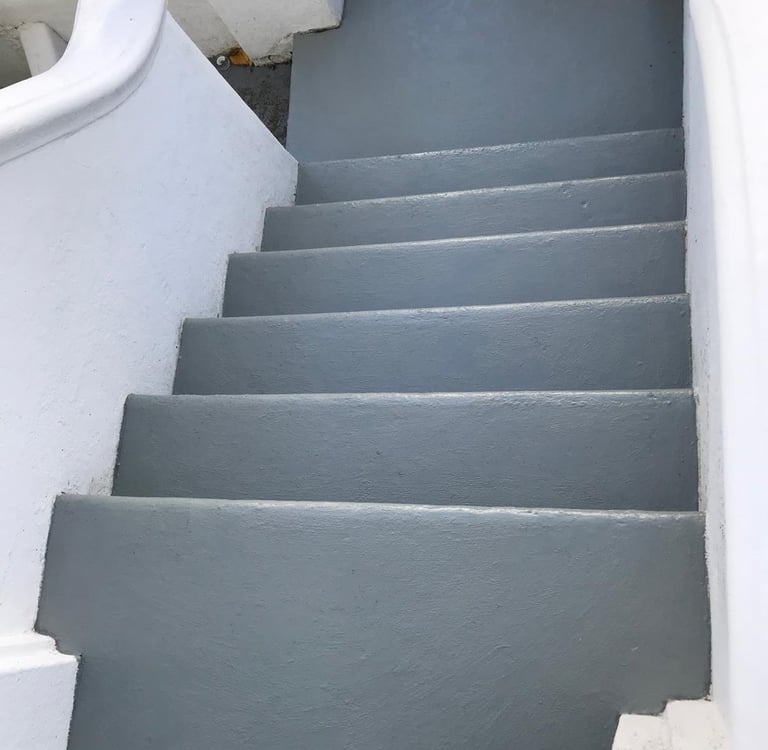 Freshly painted staircase with grey stair treads and white walls in Brighton