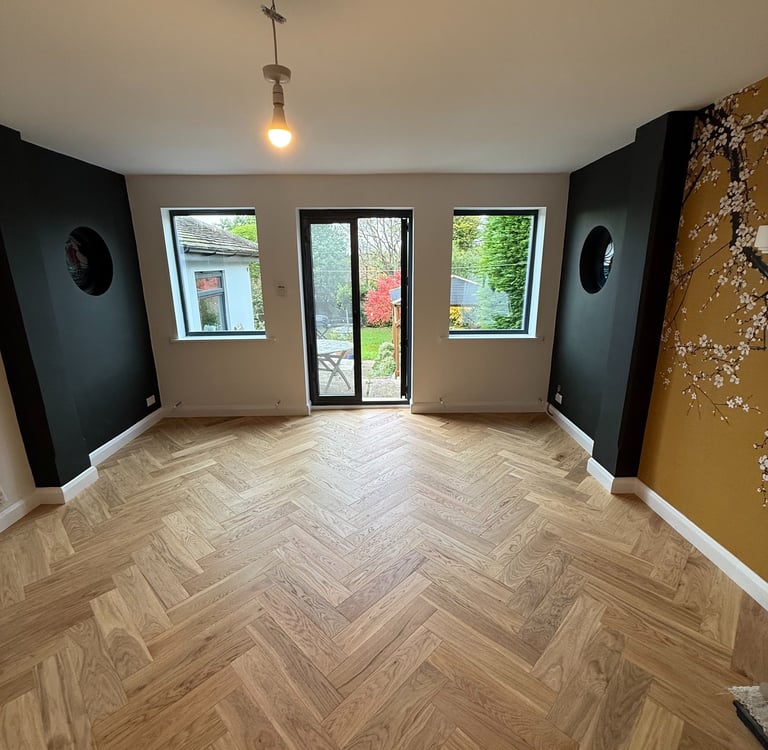 Wood flooring installation in a Brighton living room with fireplace