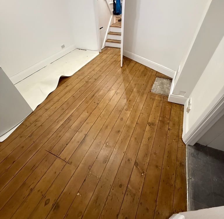 Restored wooden hallway floor in Worthing Sussex, sanded and sealed timber boards