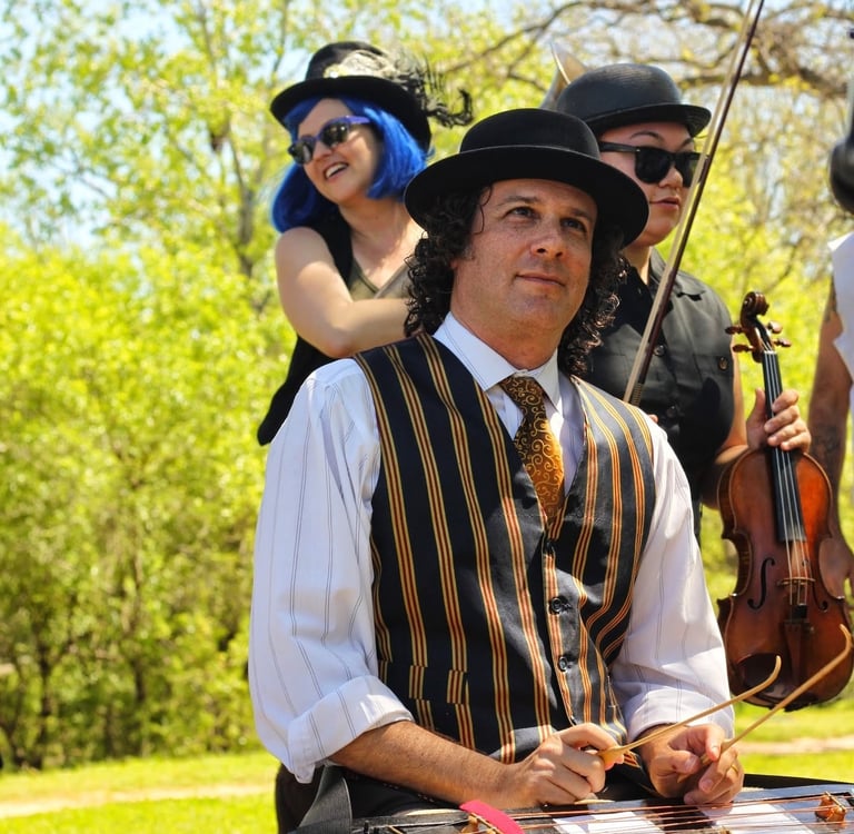 Band member playing tsimbl during a live performance with Mazel Tov Kocktail Hour