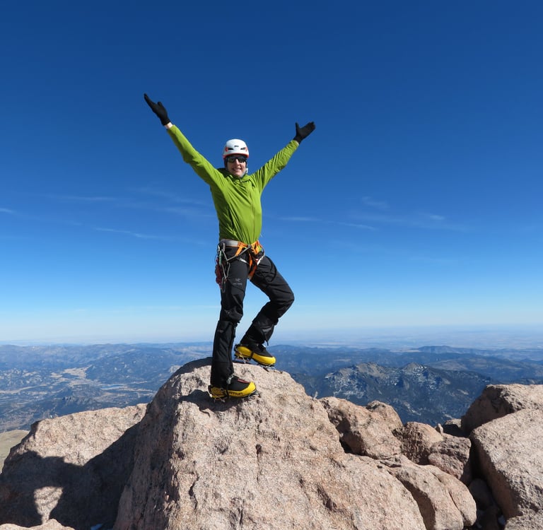 Lisa Foster on the "summit rock" on Longs Peak. This climb put her in the historical 5th place for successul summits of Longs