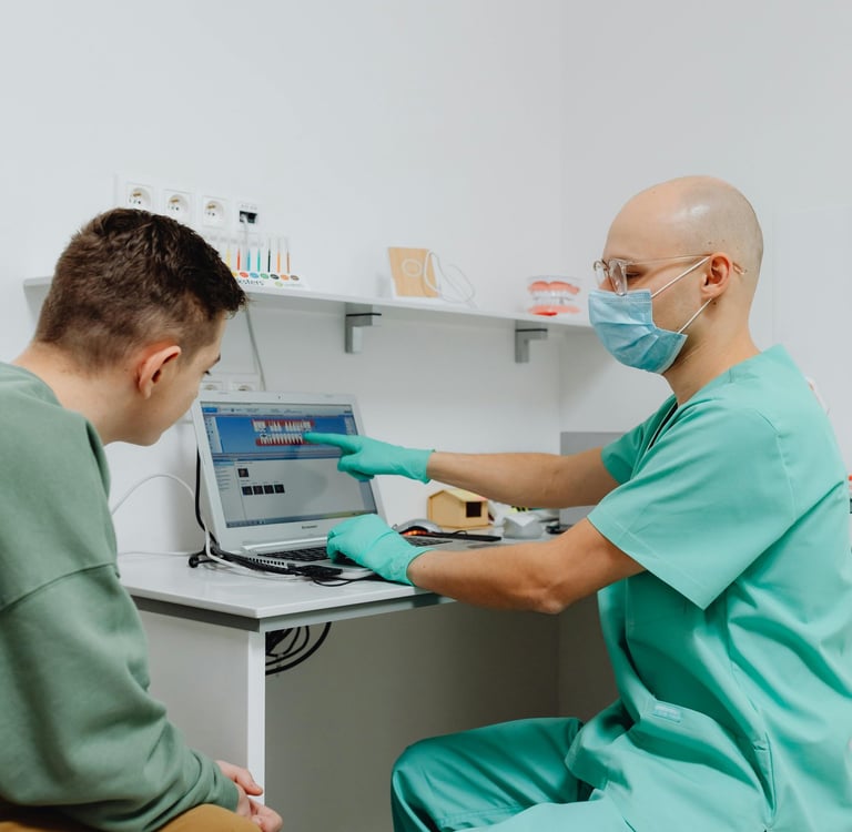 A doctor showing a patient results on a computer.