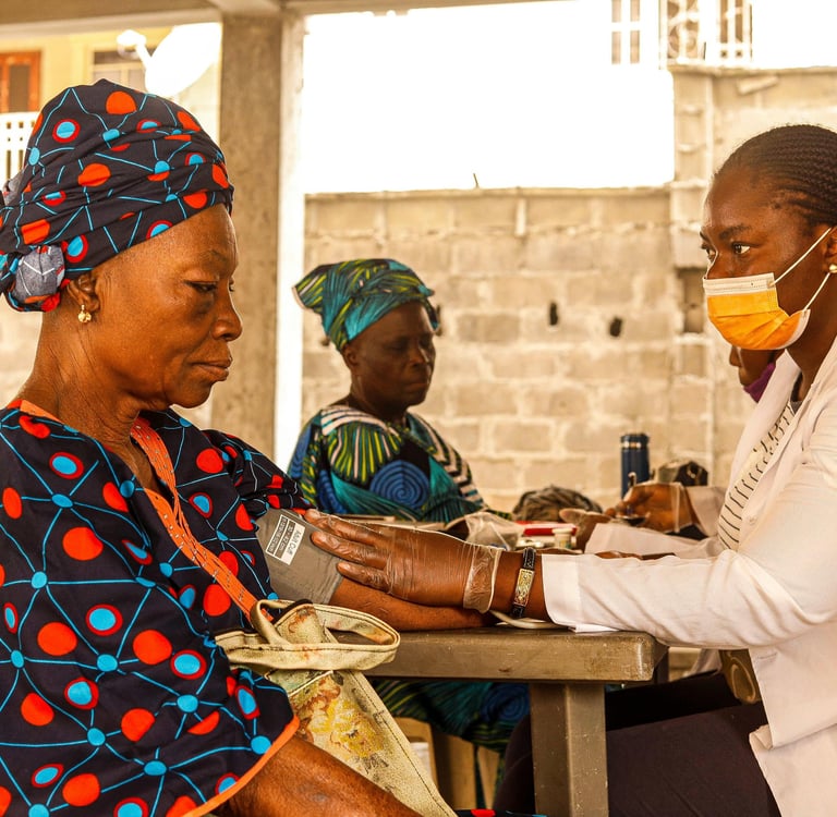 Health professional taking a woman's blood pressure.