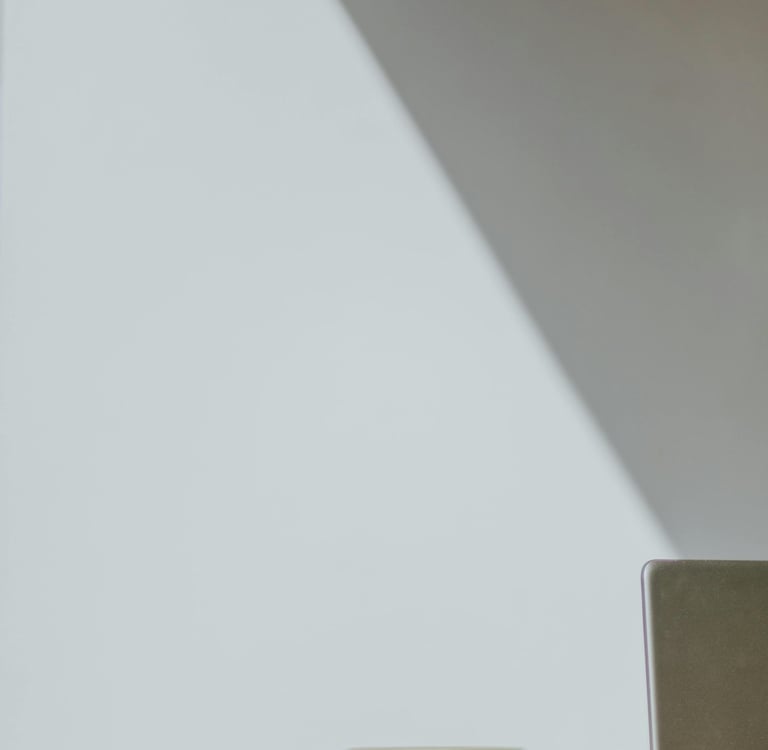 A notebook blowing open towards a laptop.