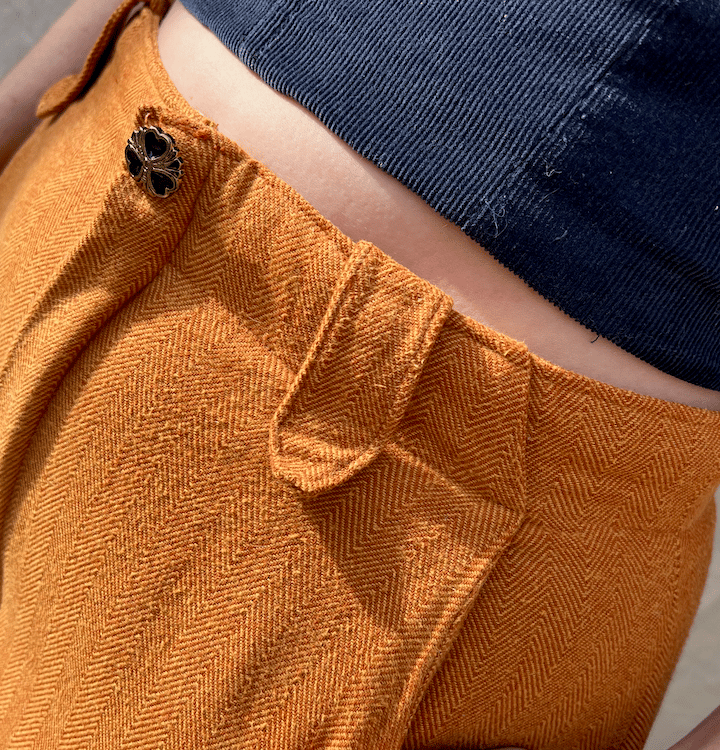 Waist detail of a navy corduroy bustier and honey brown flannel pants