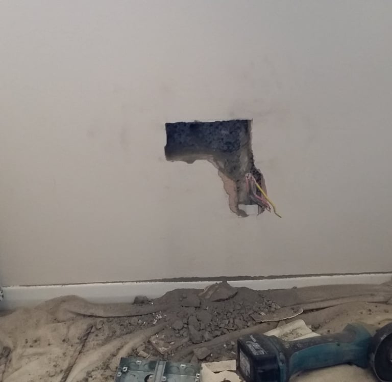 Wall being chased to fit a fused spur