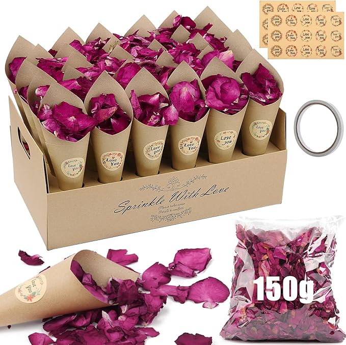 a box of pink rose petals on a table
