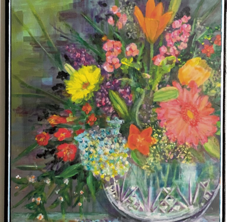 A crystal vase with colorful flowers