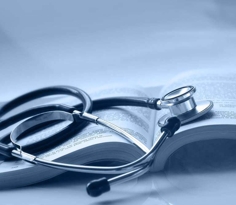 An open medical book with a stethoscope on top of it