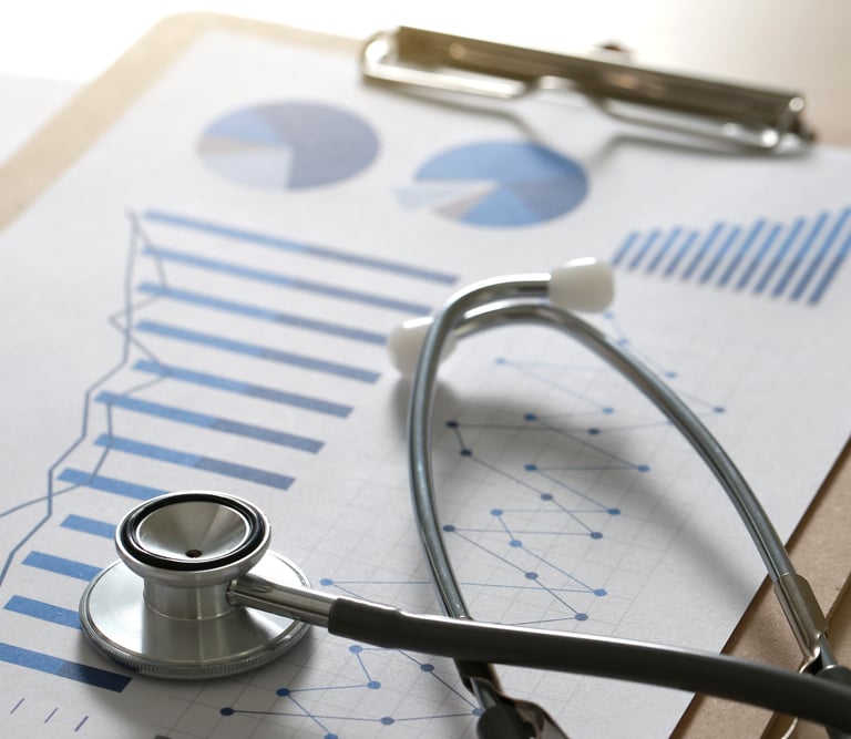 A stethoscope on top of a report with graphs on a clipboard