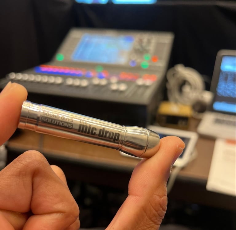 a person holding a lav mic drop in their hand