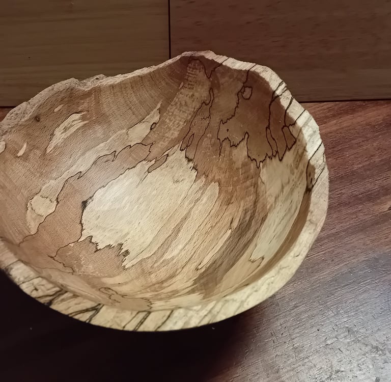 Turned spalted beech bowl with rough cleaved edge