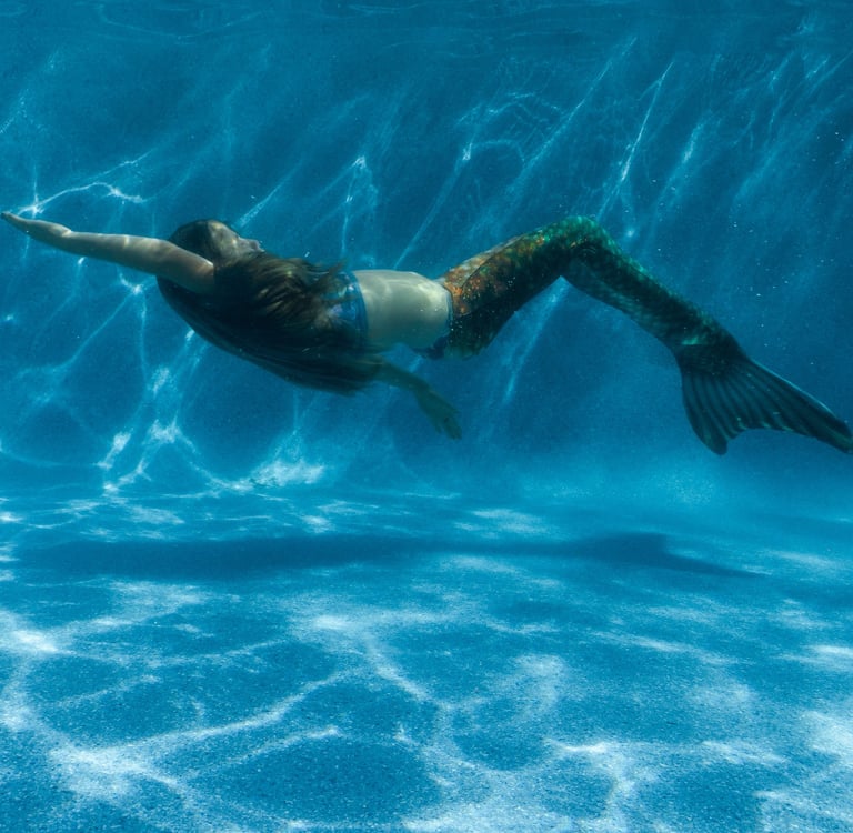 Mermaid learning how to swim in a pool