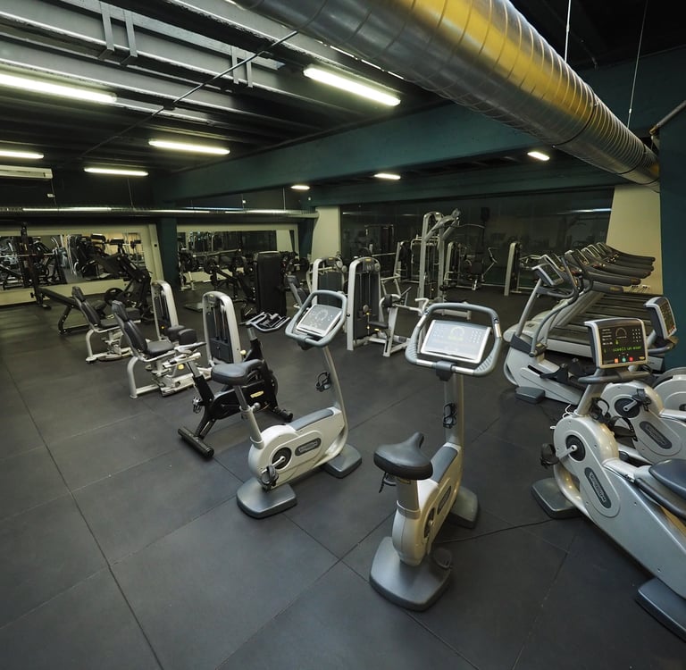 Sala fitness moderna con attrezzature per allenamento: cyclette, tapis roulant e macchine