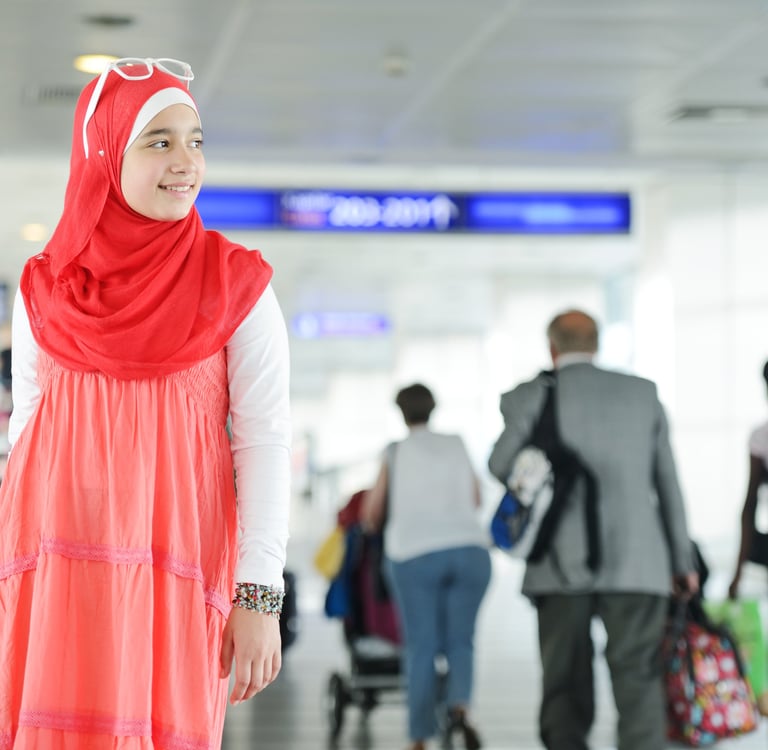 a woman in a red dress and a man in a suit for boarding 